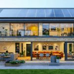 An illustration of a UK home retrofitted with solar panels, insulated walls, and energy-efficient windows, symbolizing sustainable renovation efforts.