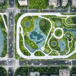 Aerial view of a city featuring advanced climate-resilient infrastructure, including flood-resistant water squares, elevated roadways, and green urban spaces designed to withstand extreme weather conditions.