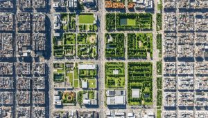 Aerial view of an urban district with a split-screen comparison showing before and after revitalization. The before side depicts aging infrastructure and sparse greenery, while the after side features modern buildings, lush green areas, and bustling activity.